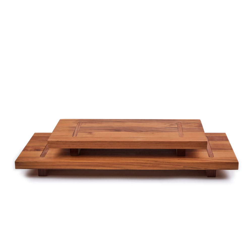 Two-tiered modular teakwood food stand with interlocking rectangular platforms isolated on white.