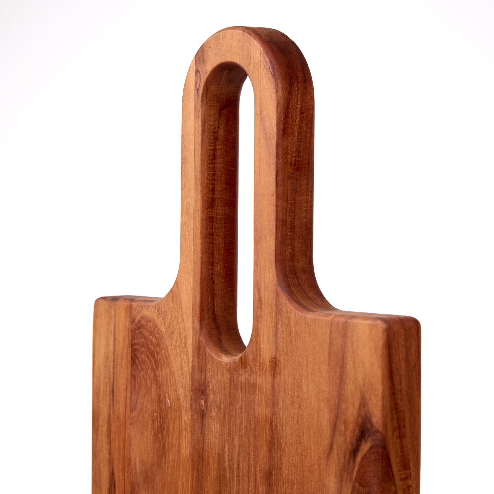 Rounded teakwood handle with a vertical cutout, showcasing the rich wood grain of the Lagom serving board.