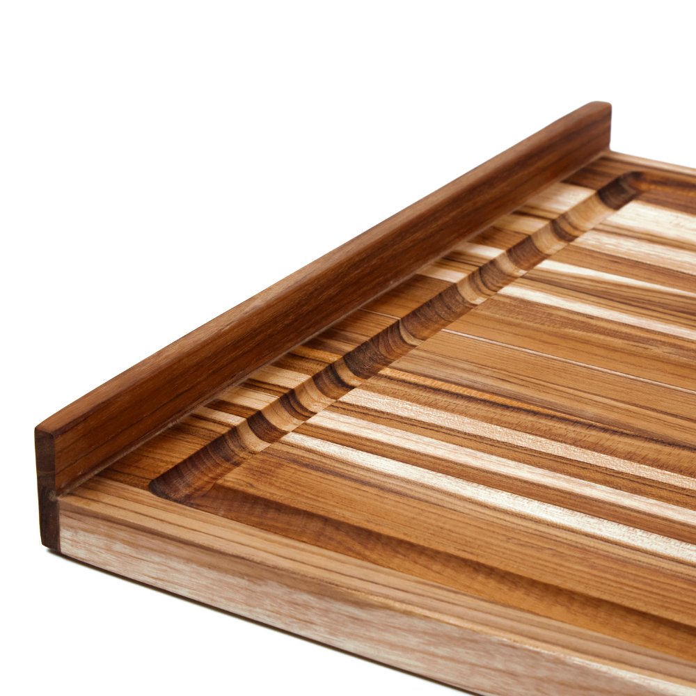 Scandi edge grain teakwood countertop board featuring an integrated lip and juice canal on a white background.