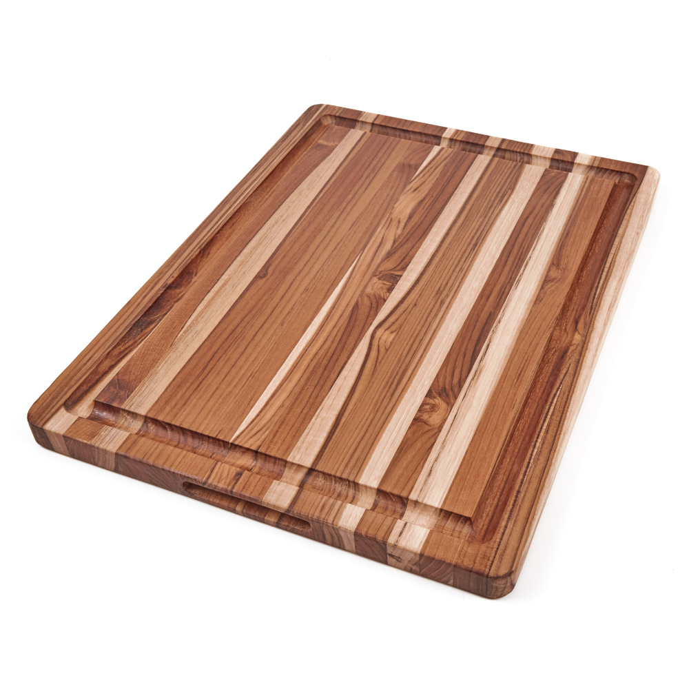 Rectangular edge grain teakwood BBQ board with a deep juice canal and handgrips, isolated on a white background.