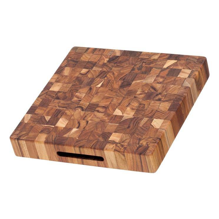 Thick square teakwood butcher block cutting board featuring a durable end grain pattern and integrated hand grips.