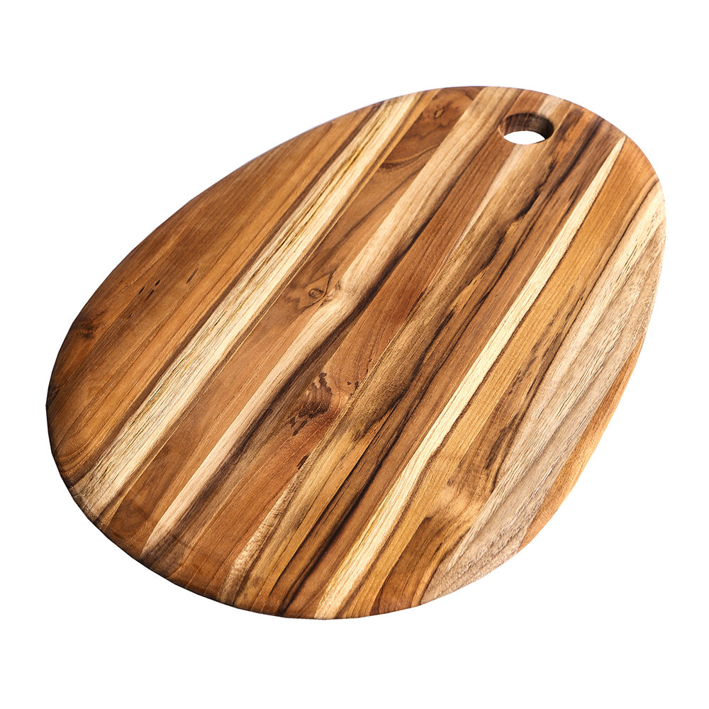 Large oval teakwood board with rich natural grain and a circular handle hole for elegant serving and cutting.