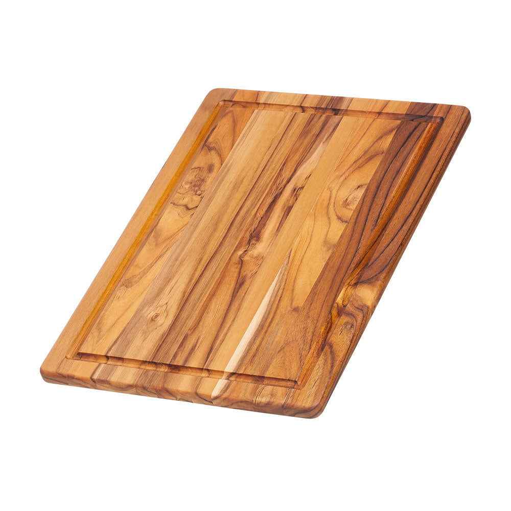 Teakwood rectangular cutting board featuring a juice canal and natural edge grain pattern.