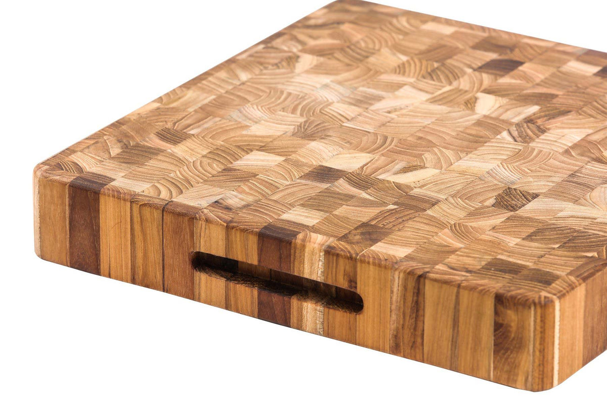 Thick square teakwood cutting board featuring a checkered end-grain pattern and recessed side hand grip.