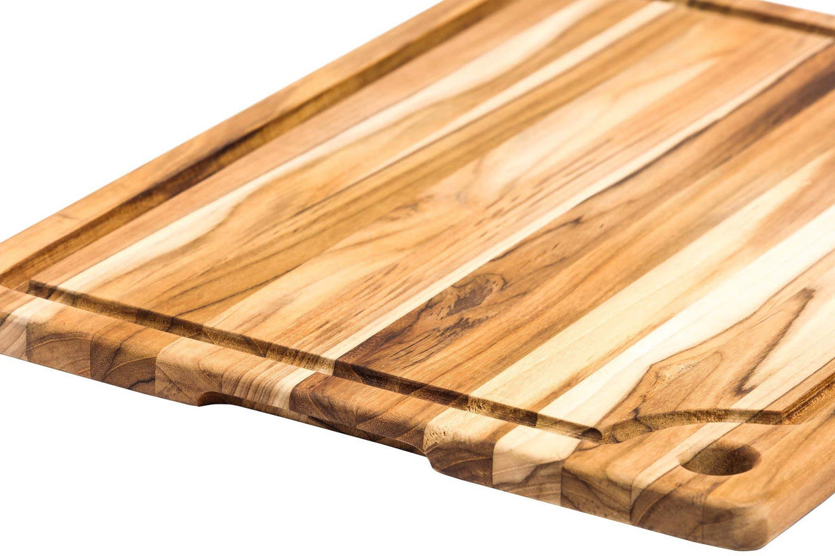 Rectangle teakwood marine cutting board with juice canal and corner hole, featuring a natural edge grain finish.