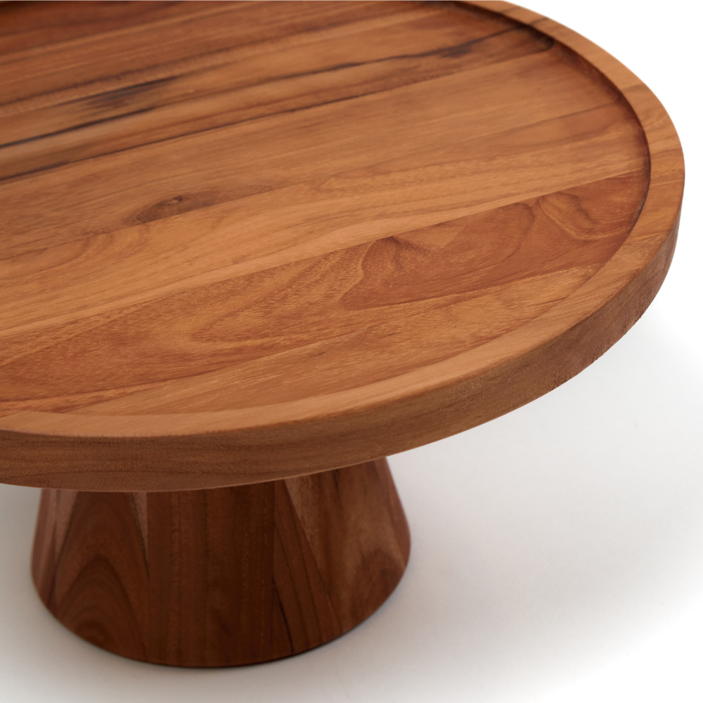 Close-up of a small traditional teakwood cake stand showing the rich wood grain and elevated pedestal base.