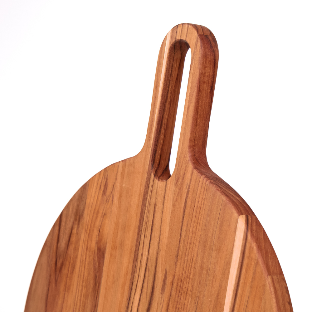 Round teakwood serving board featuring a long handle with a cutout and rich, natural wood grain.
