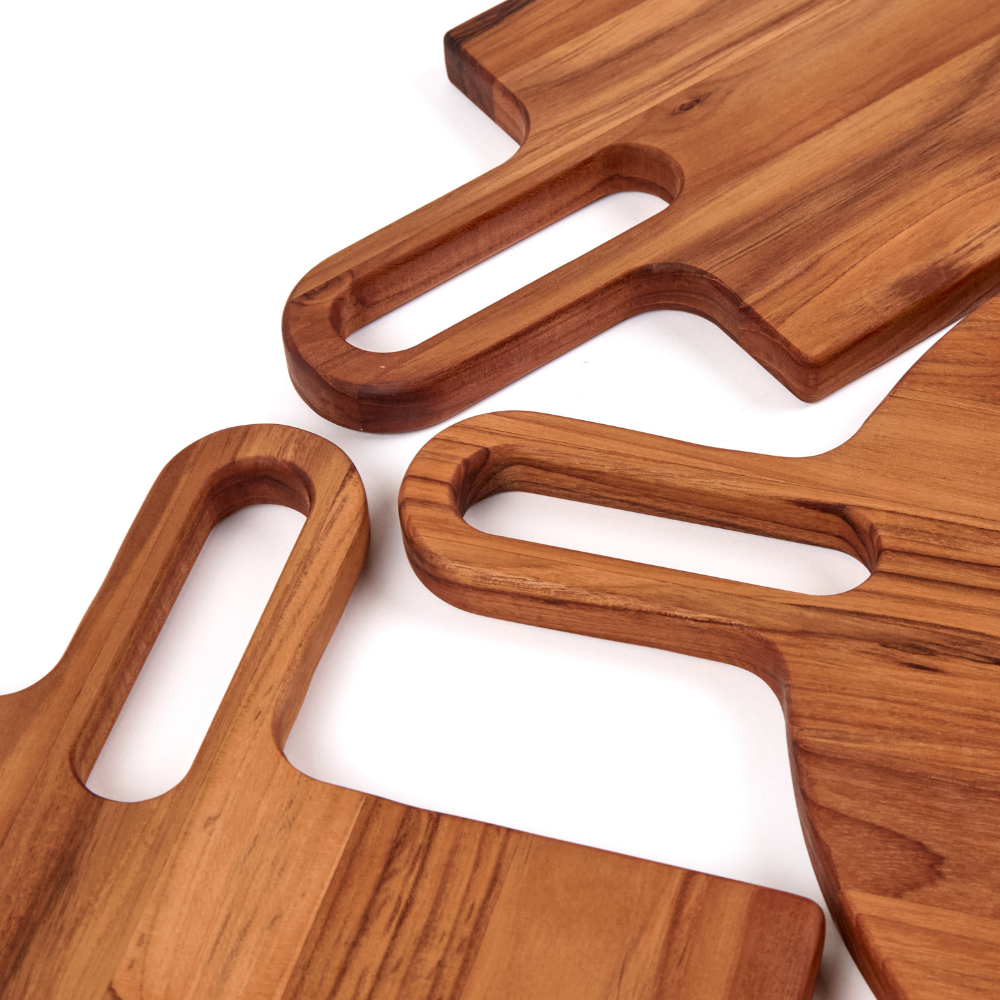 Square teakwood serving boards featuring long cutout handles and rich natural wood grain on a white background.