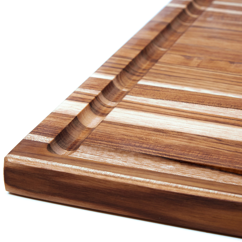 Juice canal detail on a Scandi teakwood cutting board highlighting the rich, natural edge grain.