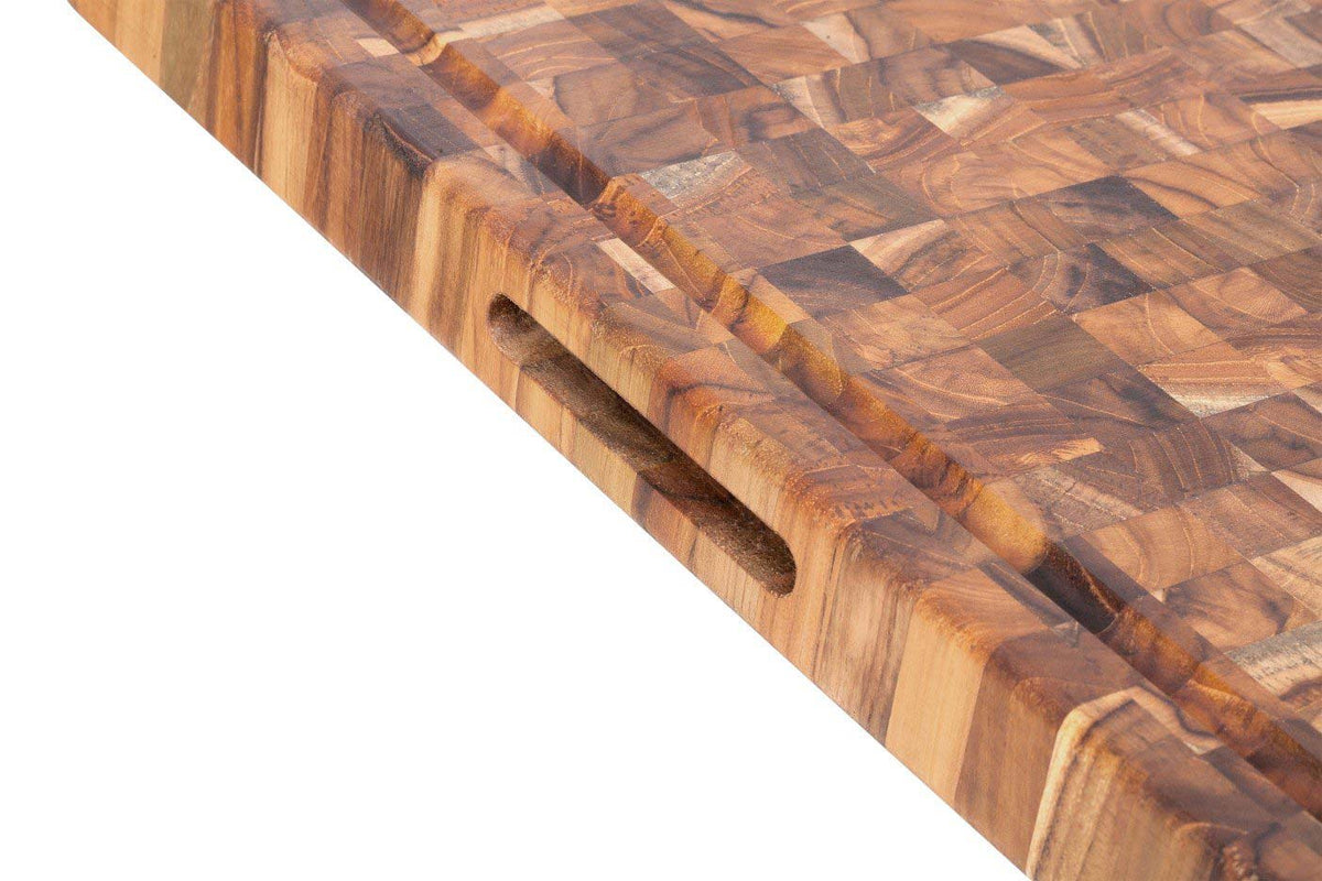 Teakwood end grain butcher block detail featuring a juice canal and built-in hand grip.