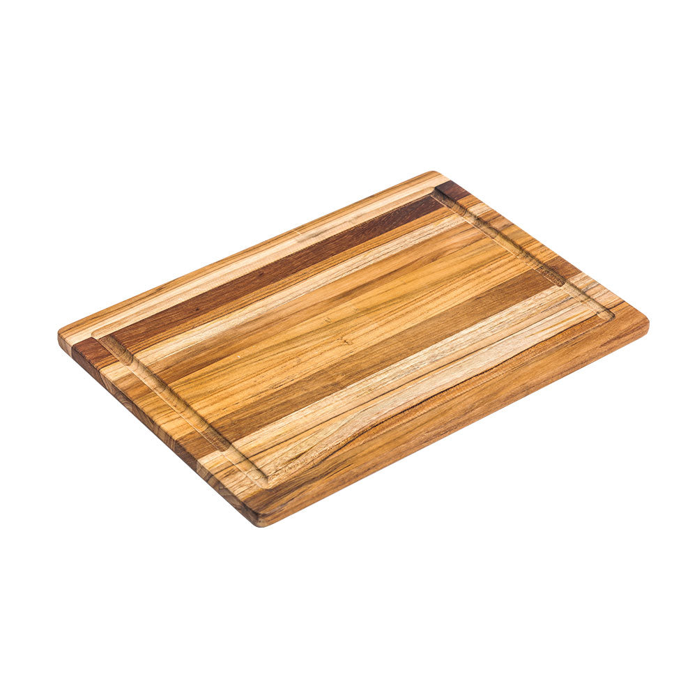 Rectangular teakwood cutting board from the Essential Collection with a built-in juice canal and edge grain.