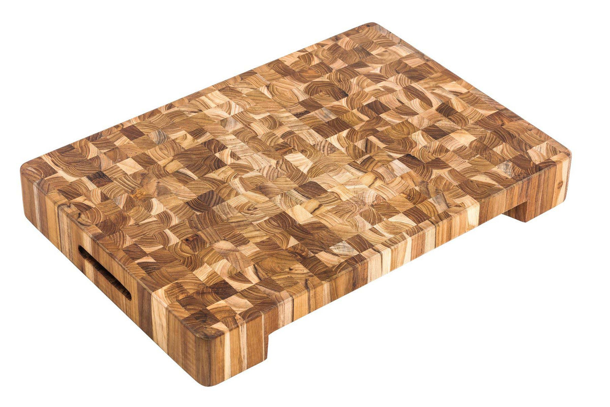 Extra thick end grain teakwood butcher block featuring built-in hand grips and a plate cutout.