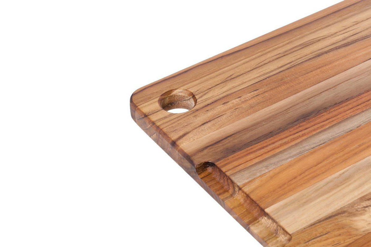 Rectangle teakwood cutting board showing edge grain detail, a deep juice canal, and a convenient corner hole.