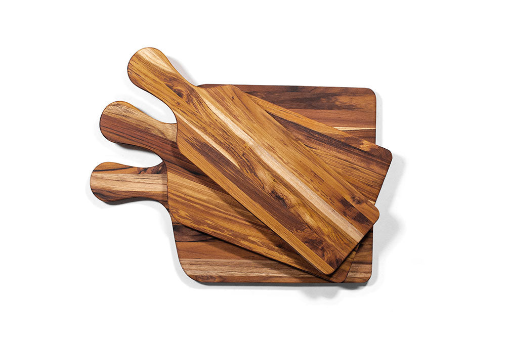 Teak wood marine paddle serving boards stacked on a clean white background.