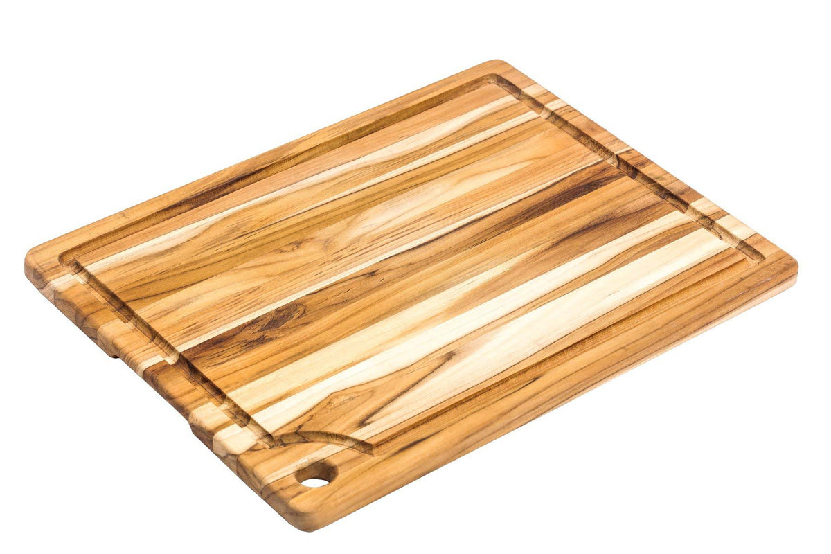 Rectangular teakwood marine cutting board with edge grain, a juice groove, and a corner hole.