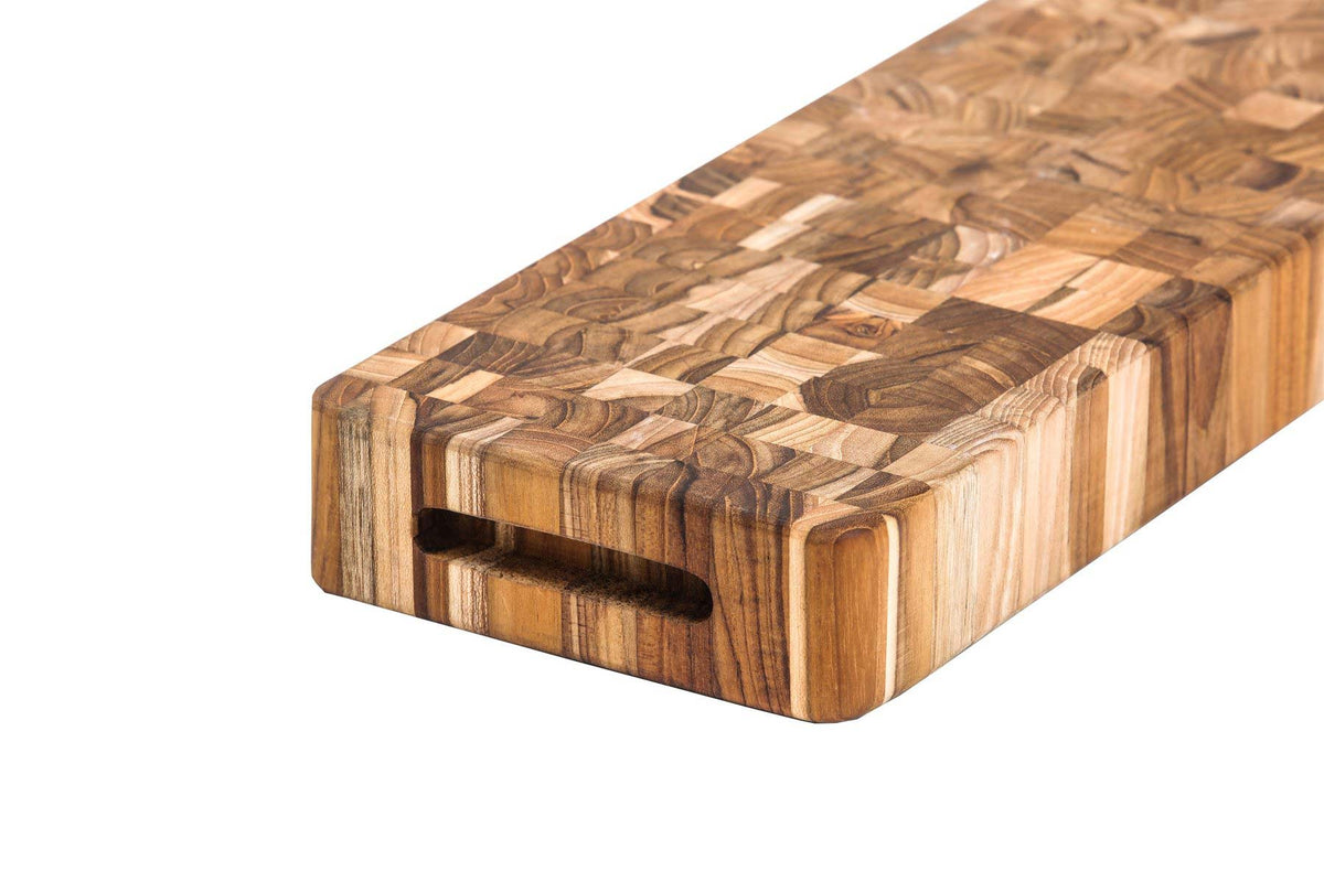 Thick end grain teak wood butcher block cheese board with an integrated hand grip and natural mosaic wood patterns.