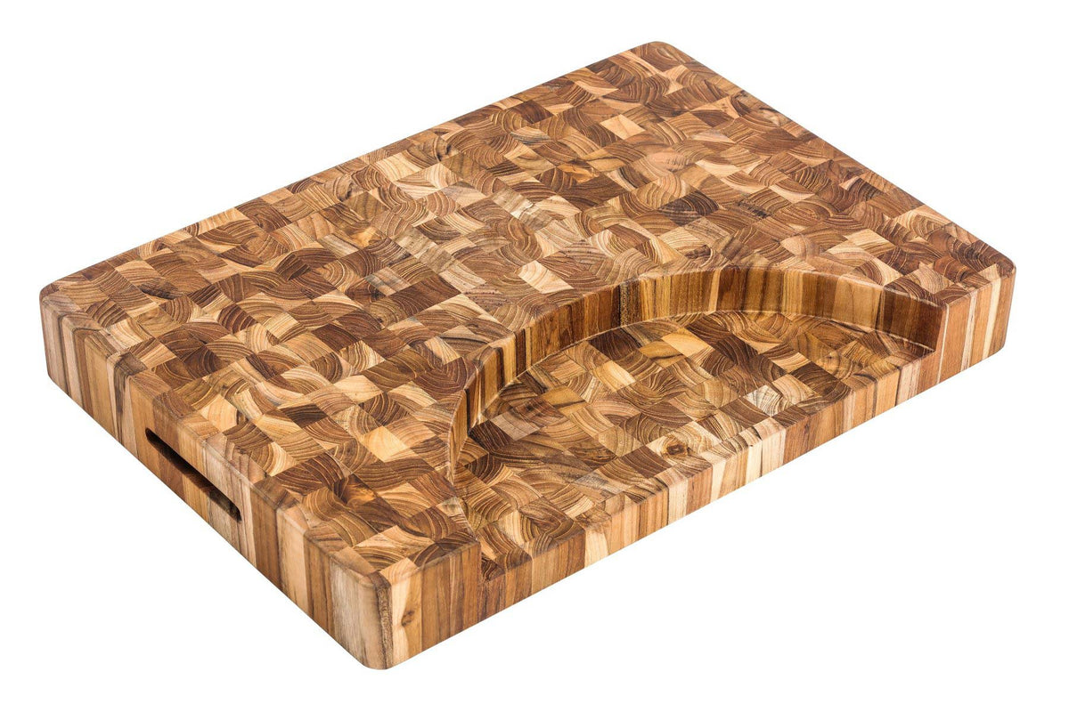 Extra thick teak end grain butcher block with a curved plate cutout and integrated hand grips.