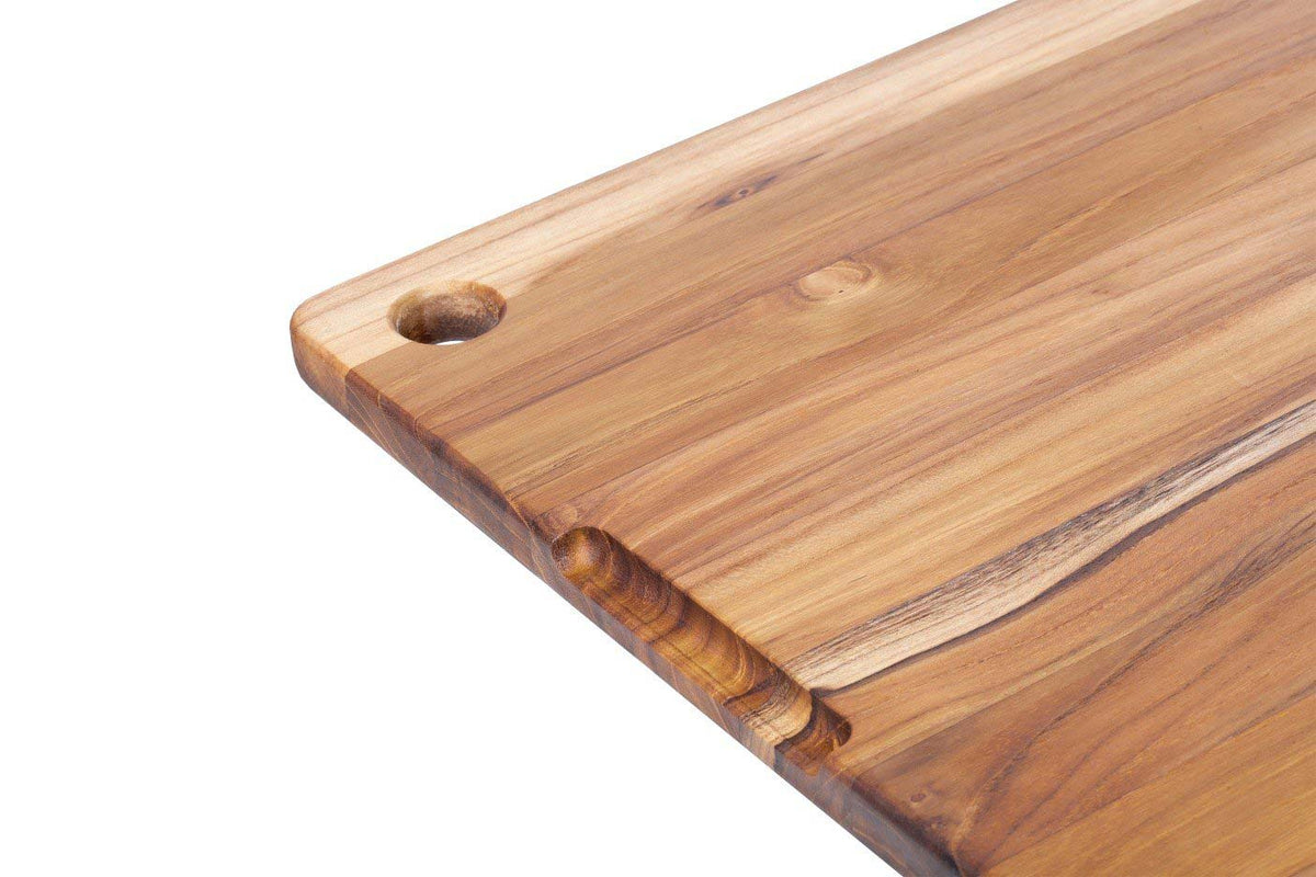 Rectangular teakwood chopping board featuring edge grain, a corner hole, and a perimeter juice canal.