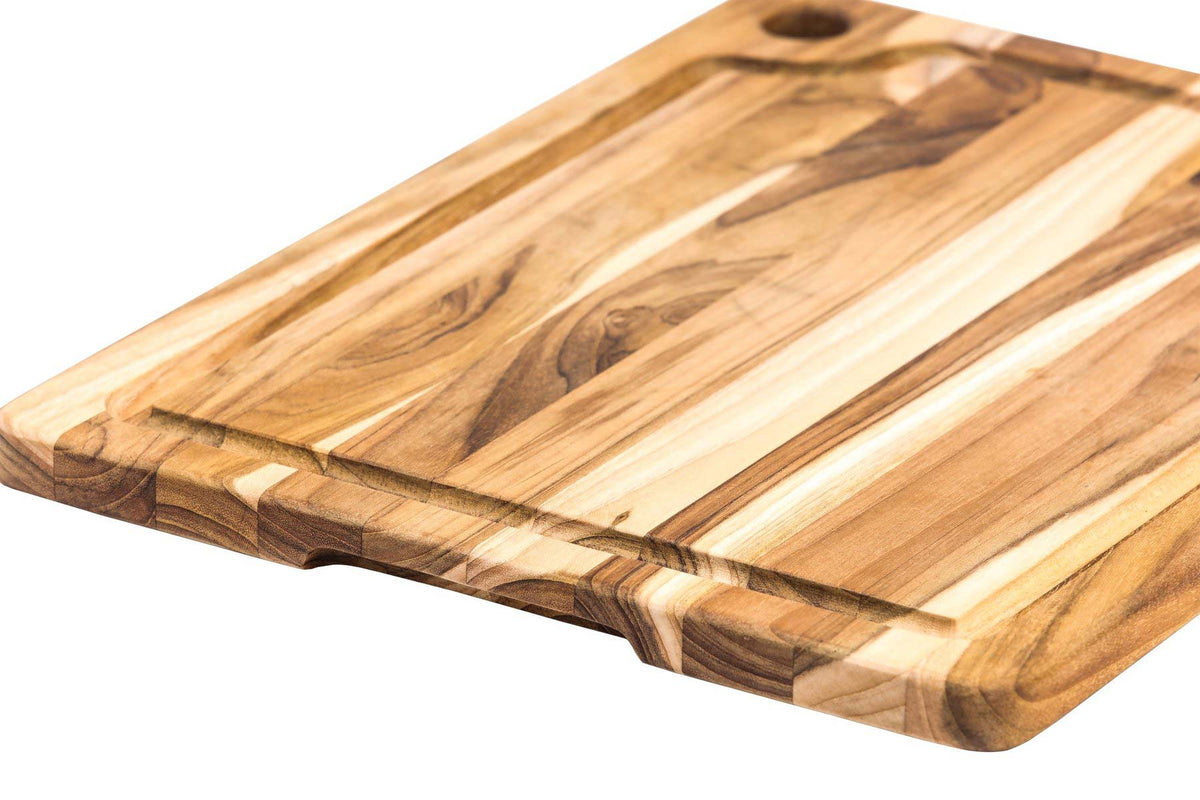 Rectangle edge grain teakwood chopping board featuring a juice canal, corner hole, and rich wood patterns.