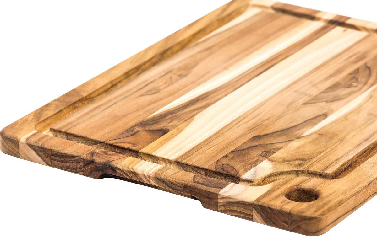 Rectangle teakwood chopping board featuring an edge grain, deep juice canal, and a functional corner hole.